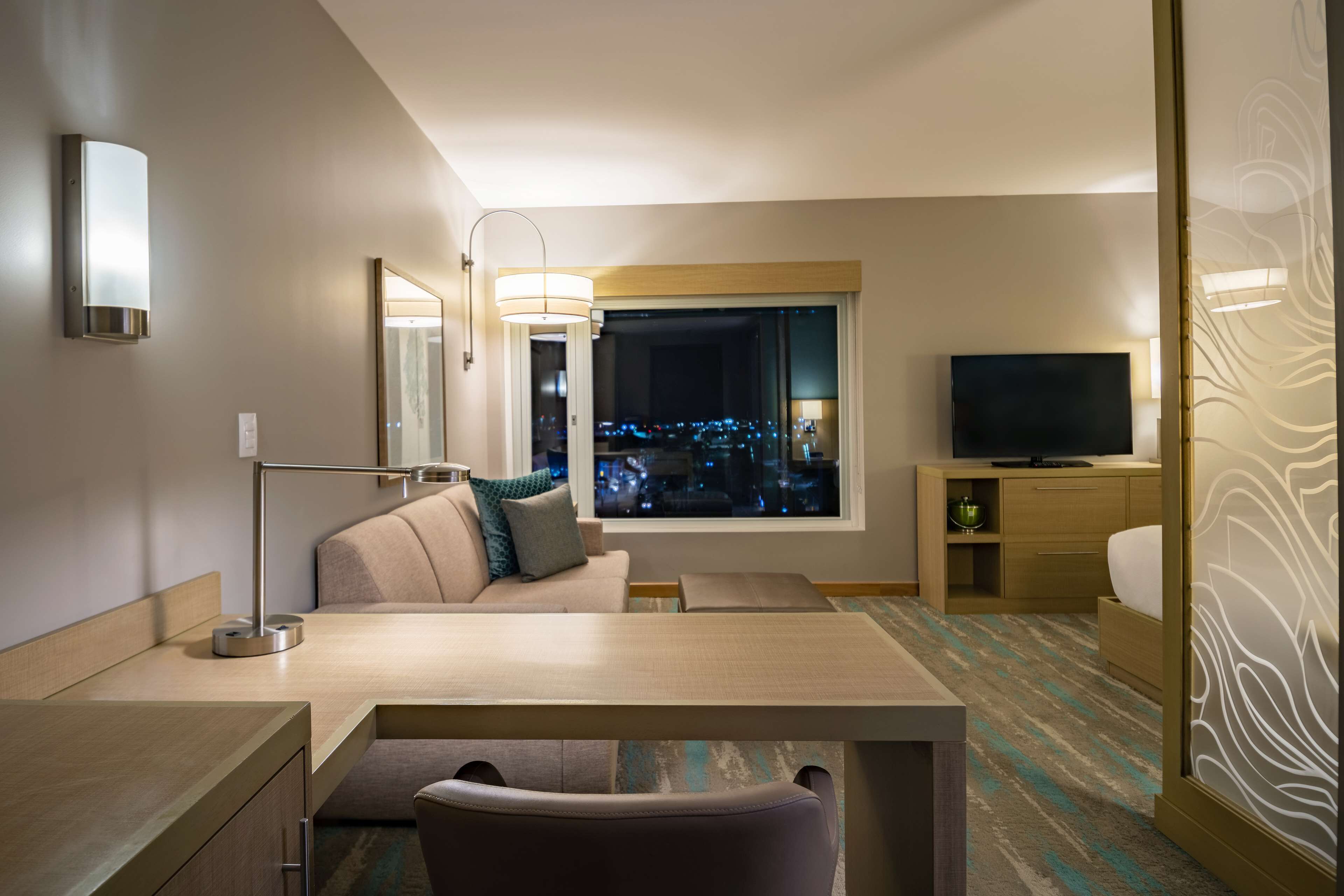 room, 1 king bed with sofa bed (airport view) | living area | flat-screen tv