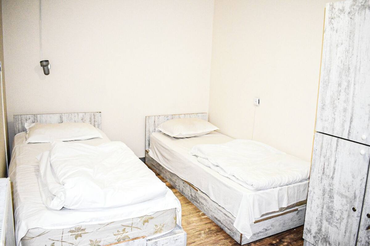 Economy Twin Room, Shared Bathroom | Soundproofing, iron/ironing board (on request), WiFi (free), bed sheets