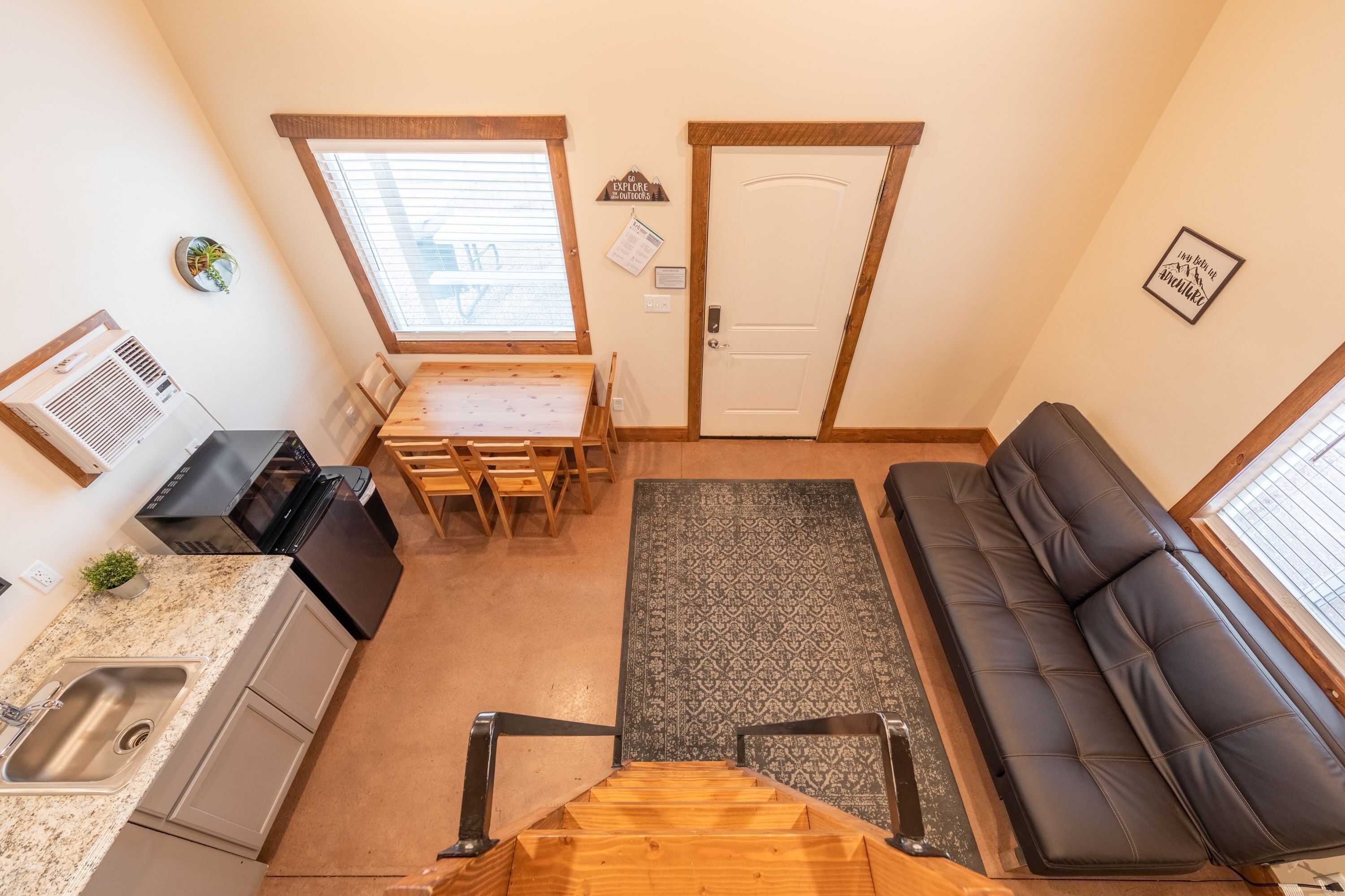 A compact living space with a kitchenette, dining area, and seating area.