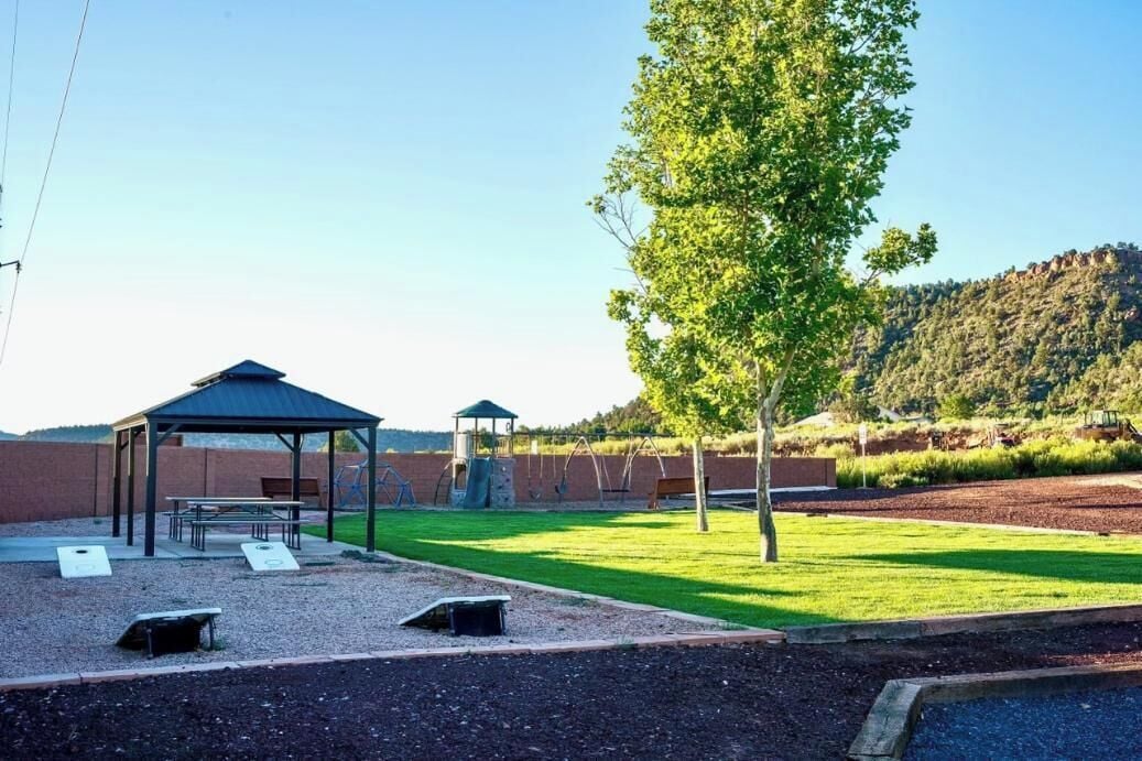 A gazebo, picnic tables, and a playground with swings.