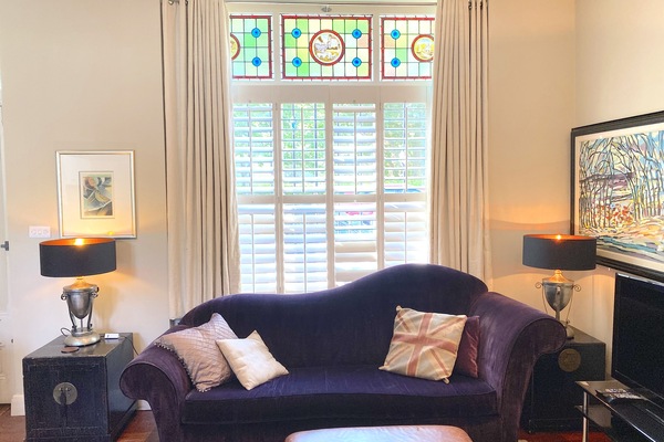 The living room with one of 2 sofas