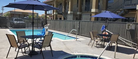 Outdoor pool, open 9:00 AM to 9:00 PM, pool umbrellas