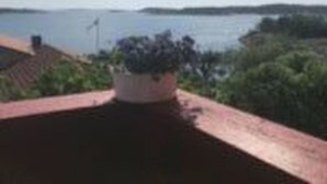 A view from a balcony overlooking a body of water with distant land and greenery. - Solferie Konsul Wilds vei 30b (Kristiansand)