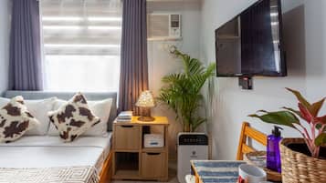 Premium bedding, desk, laptop workspace, blackout drapes