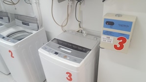Two front-loading washing machines with control panels, marked with the number 3, and a Timtron washing machine box with a price tag of 200 yen. - Chura Cabin Kokusai-Dori (Naha)