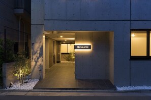 A modern building entrance with a sign reading "PHILIPPE" and a pathway leading to the interior. - B4  Maison Philippe Shitaya 402 (Tokyo)
