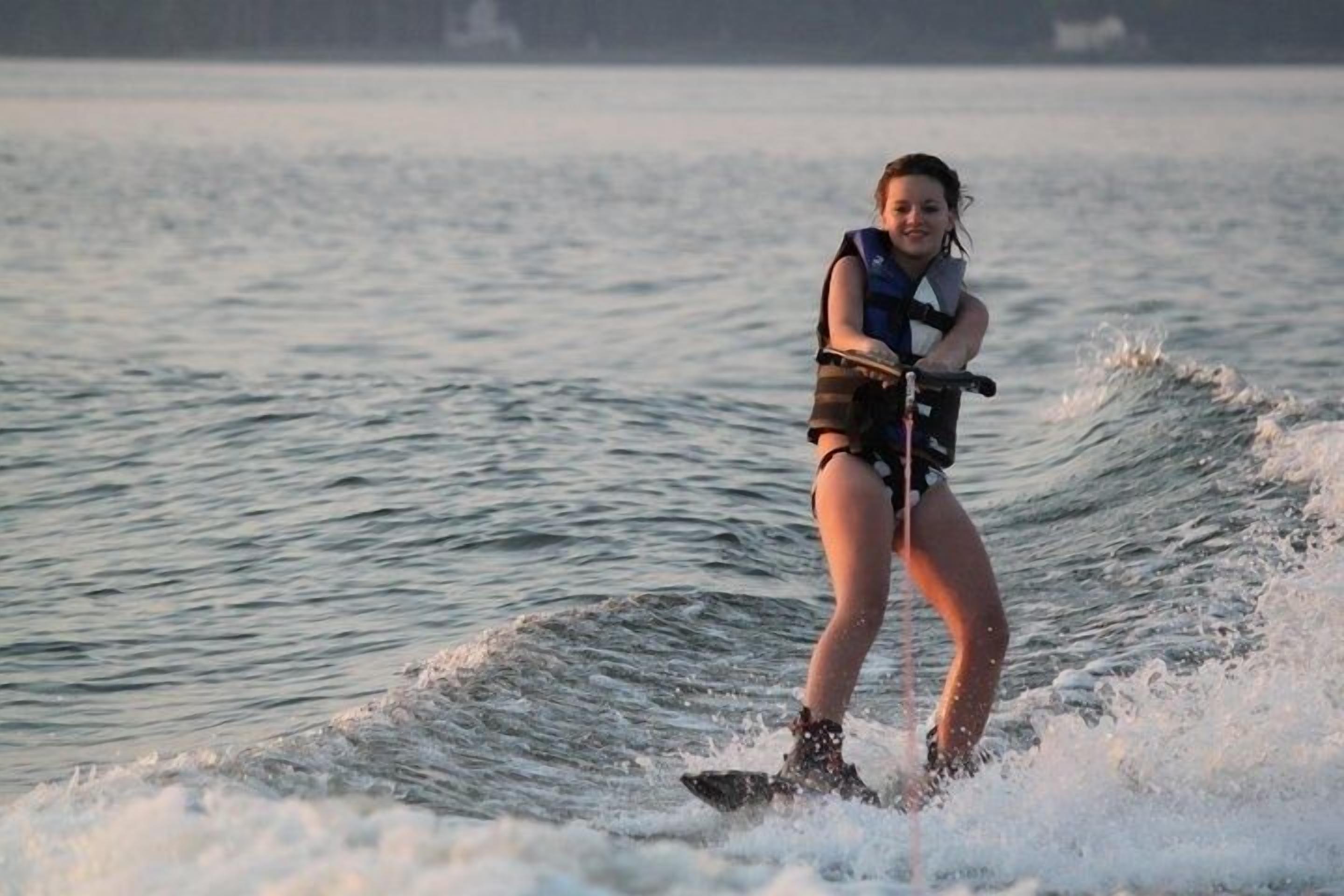 A person wakeboarding on a body of water.