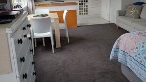 A modern kitchen with white cabinets, a wooden countertop, and hanging pendant lights. - Fab Studio Plus!!- Pukekura Park/CBD right there (New Plymouth)