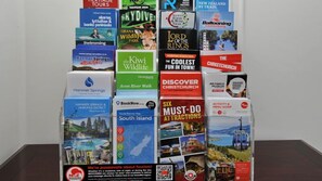 A collection of travel brochures and maps for various attractions and activities.