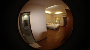 A room with a bed, a bedside table, and a window with curtains. - Law Ka Thit Sar Hotel - Hostel (Nyaung-U)