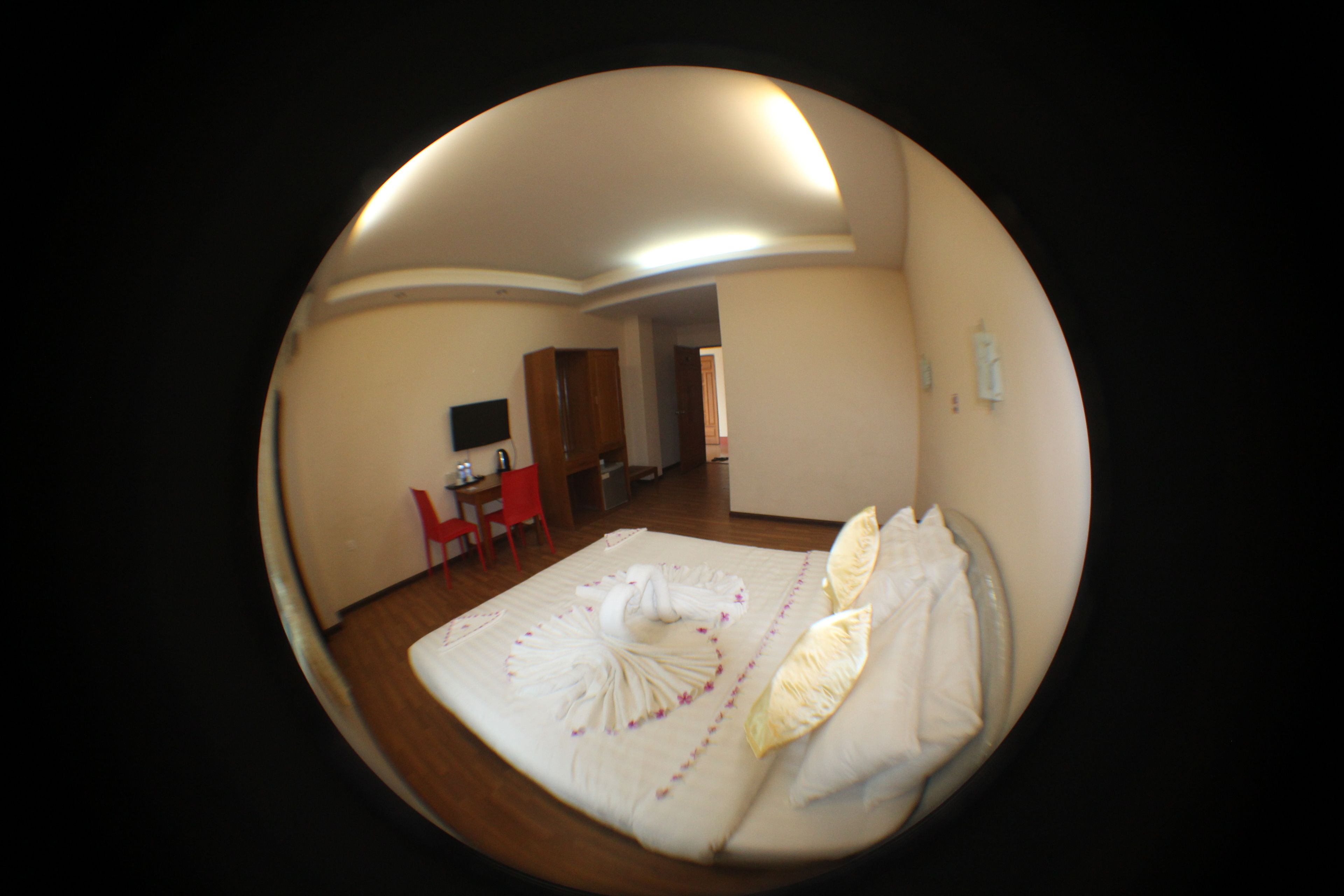 A room with a bed, a desk, and a chair.