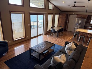 A spacious living area with a dining table, a sofa, and a kitchen with a large island.