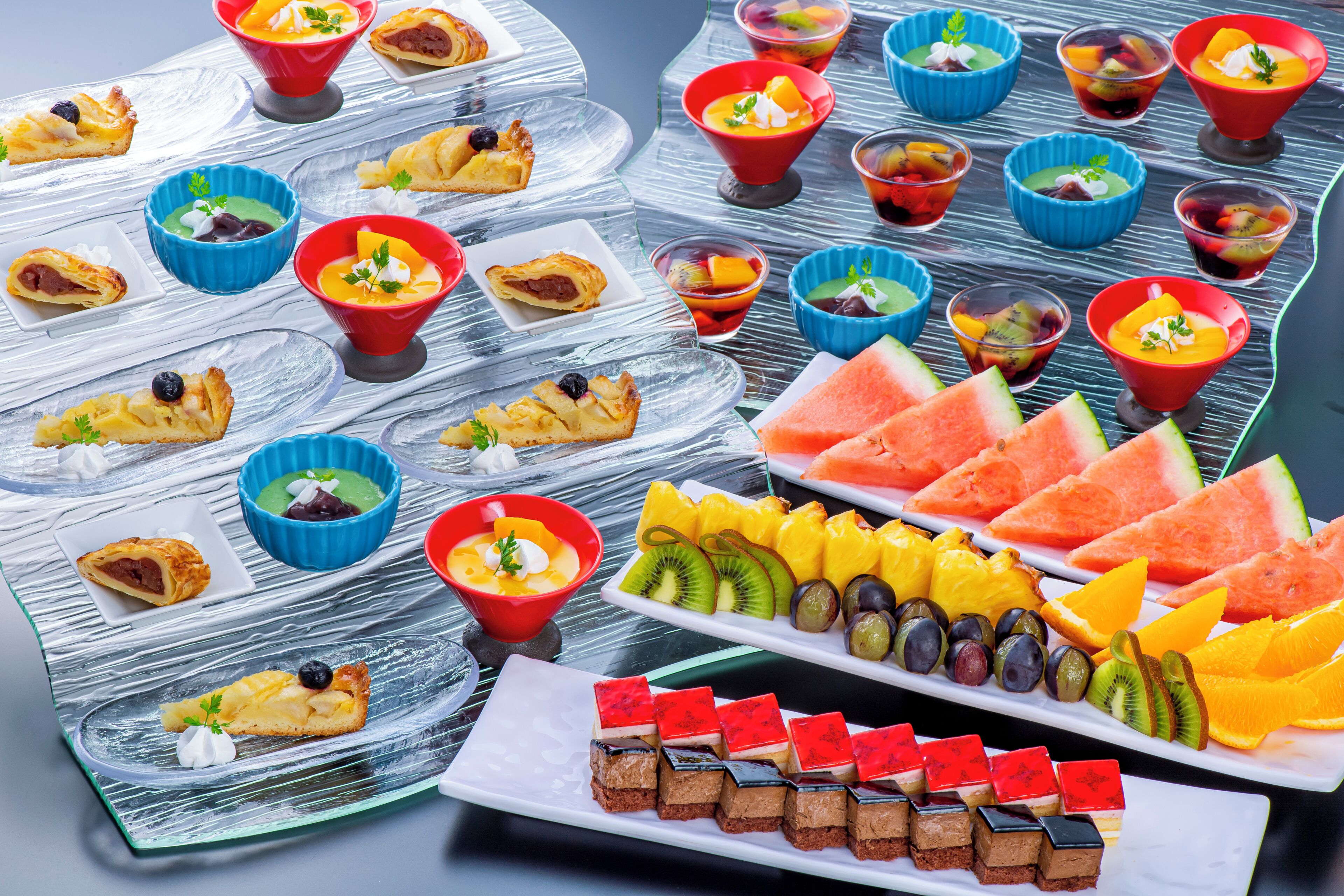 A variety of desserts and fruits arranged on a table.