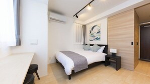 A modern bedroom with a bed, bedside table, and a painting on the wall. - C4 Maison Philippe Shitaya 403 (Tokyo)