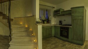 A kitchen with wooden cabinets, a stove, and a sink. - VILLA SALVIA**** Rakalj  (Rakalj)