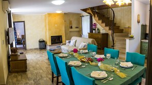 A dining area with a long table set for six, surrounded by teal chairs. A staircase is visible in the background, leading to an upper floor. - VILLA SALVIA**** Rakalj  (Rakalj)
