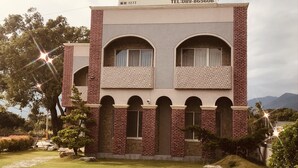 A two-story building with a brick facade, arched windows, and a sign indicating it is a restaurant. - Min Min Bed and Breakfast (Chishang)