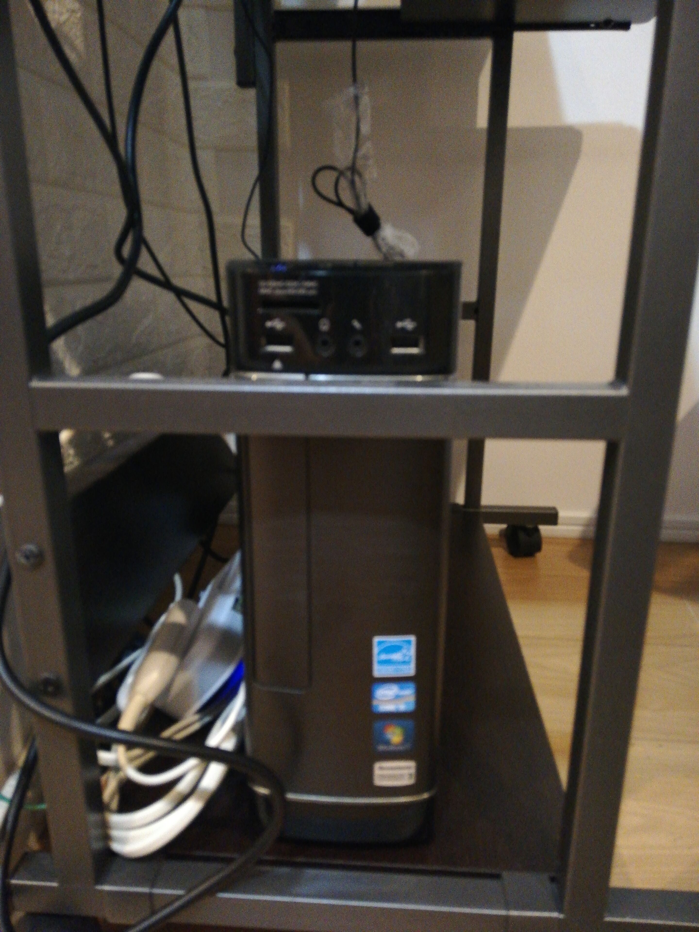 A computer setup with a monitor, keyboard, and mouse on a desk.