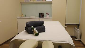 Cozy retreat with a comfortable bed, radiator, and shelf for personal belongings.