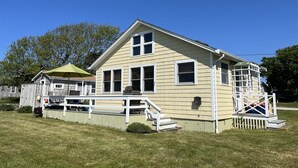 A two-story house with a front porch and a small deck. - Ocean Front Cottage! (Westport)