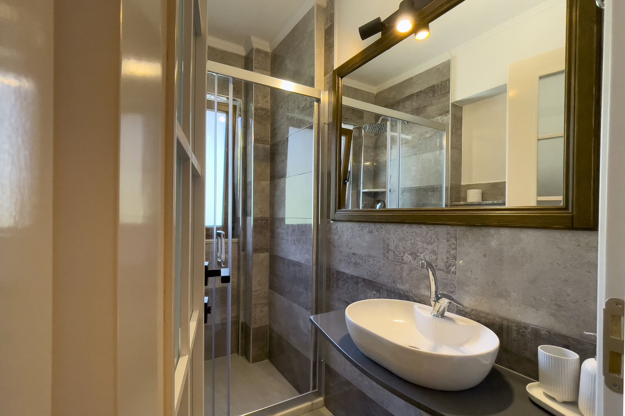 deluxe studio suite, partial sea view | bathroom | shower, rainfall showerhead, hair dryer, slippers