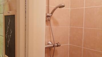 A shower with a handheld showerhead and a handheld hose.