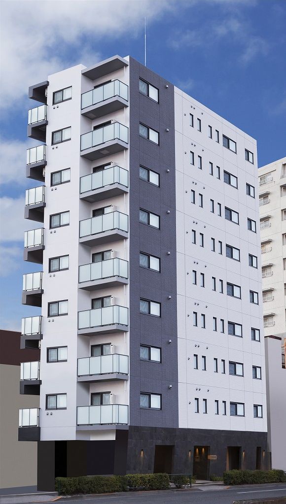 A multi-story building with balconies, large windows, and a flat roof.