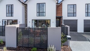 A modern two-story house with a garage, a covered patio, and a landscaped garden. - Restful in Riccarton - Christchurch (Christchurch)