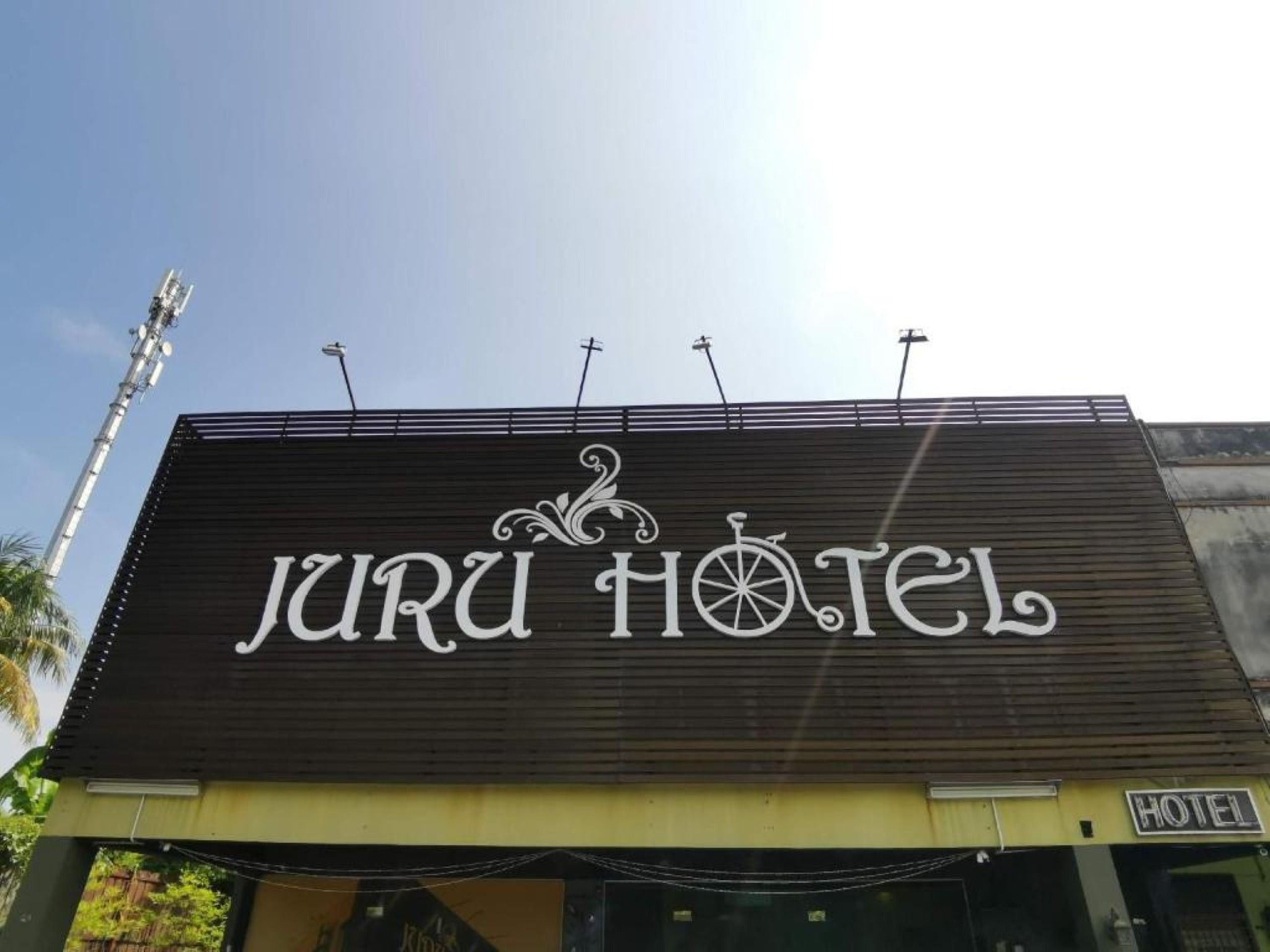 En byggnad med en skylt där det står ”Juru Hotel”.