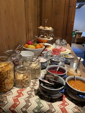 Una mesa de buffet con distintos alimentos y condimentos.