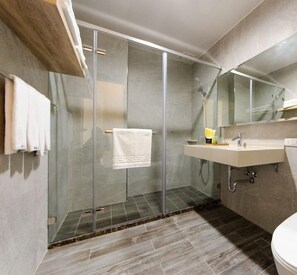 Habitación cuádruple familiar, balcón | Baño | Regadera, regadera tipo lluvia, amenidades de baño gratuitas 