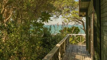 Step out onto the deck and enjoy the serene sea views from this coastal cabin.