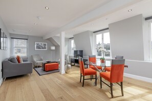 Departamento superior, 2 habitaciones, vista a la ciudad | Área de sala de estar | Smart TV 