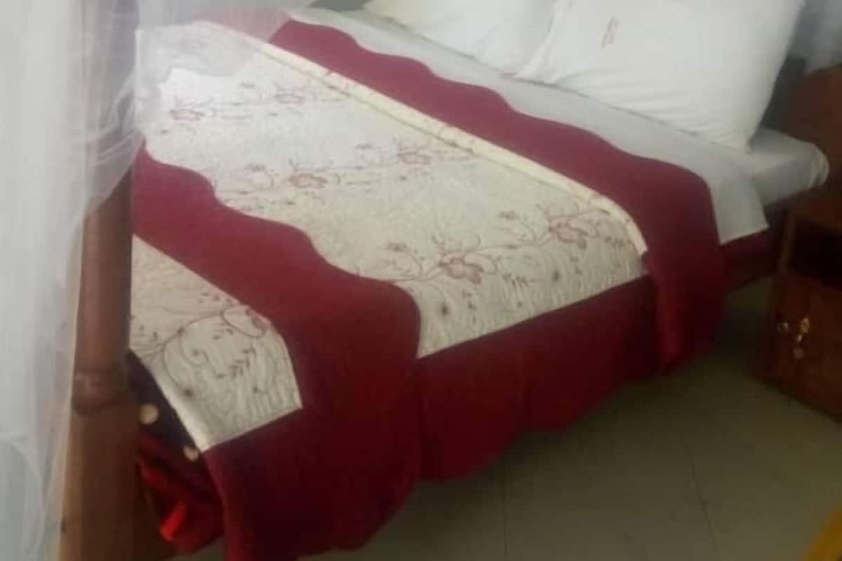 Desk, laptop workspace, blackout drapes, bed sheets