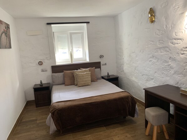 A bedroom with a bed, bedside tables, a desk, and a window. - Valtisya House Pool & Airport (Telde)