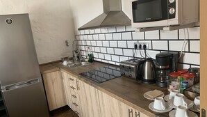 A kitchen with a stainless steel refrigerator, a microwave, a toaster, and a coffee maker. - Valtisya House Pool & Airport (Telde)
