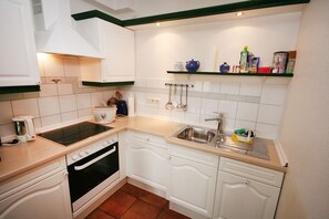 Apartamento | Cozinha privada | Geladeira, fogão, cooktop, lava-louças