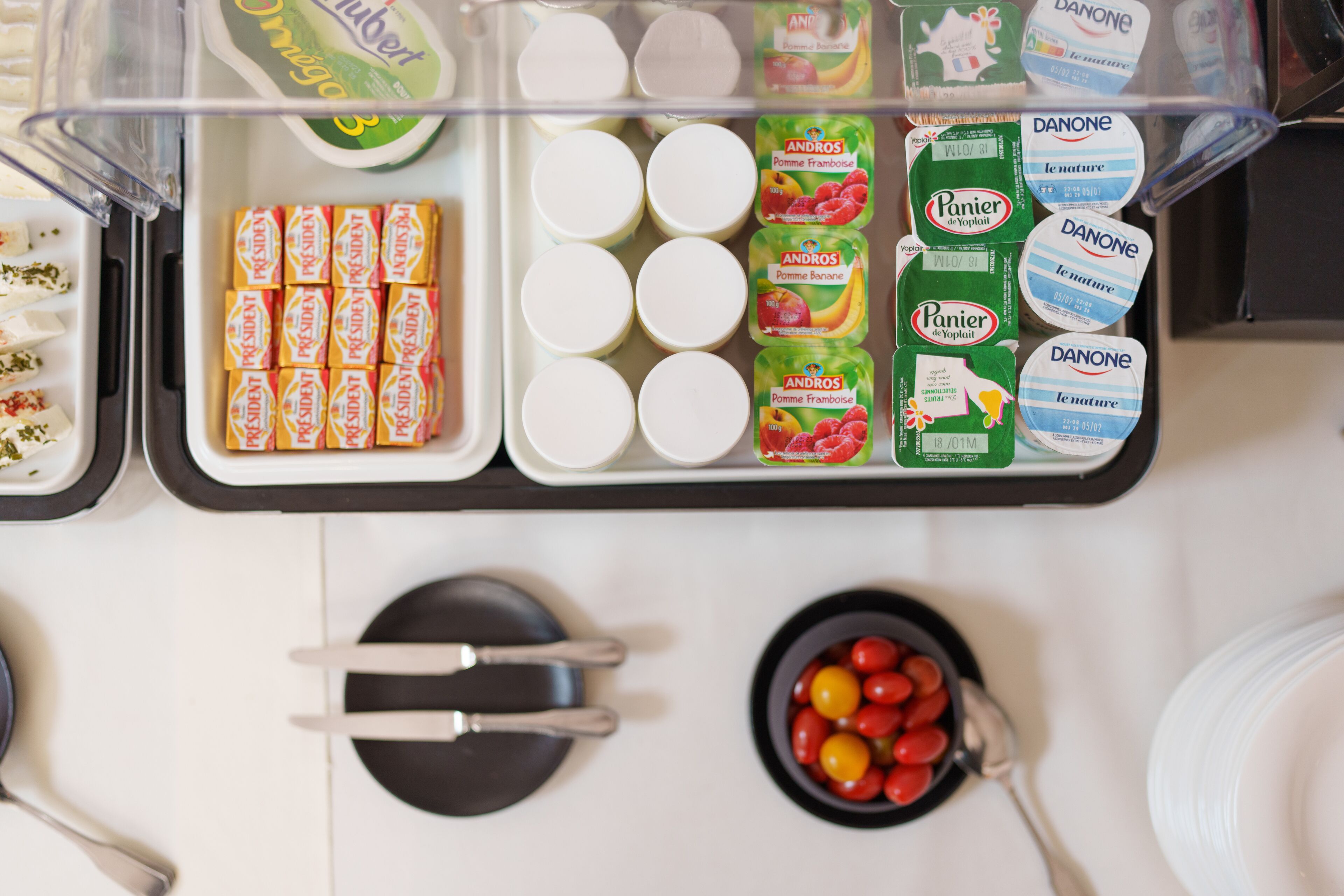A breakfast buffet with various food items and containers.
