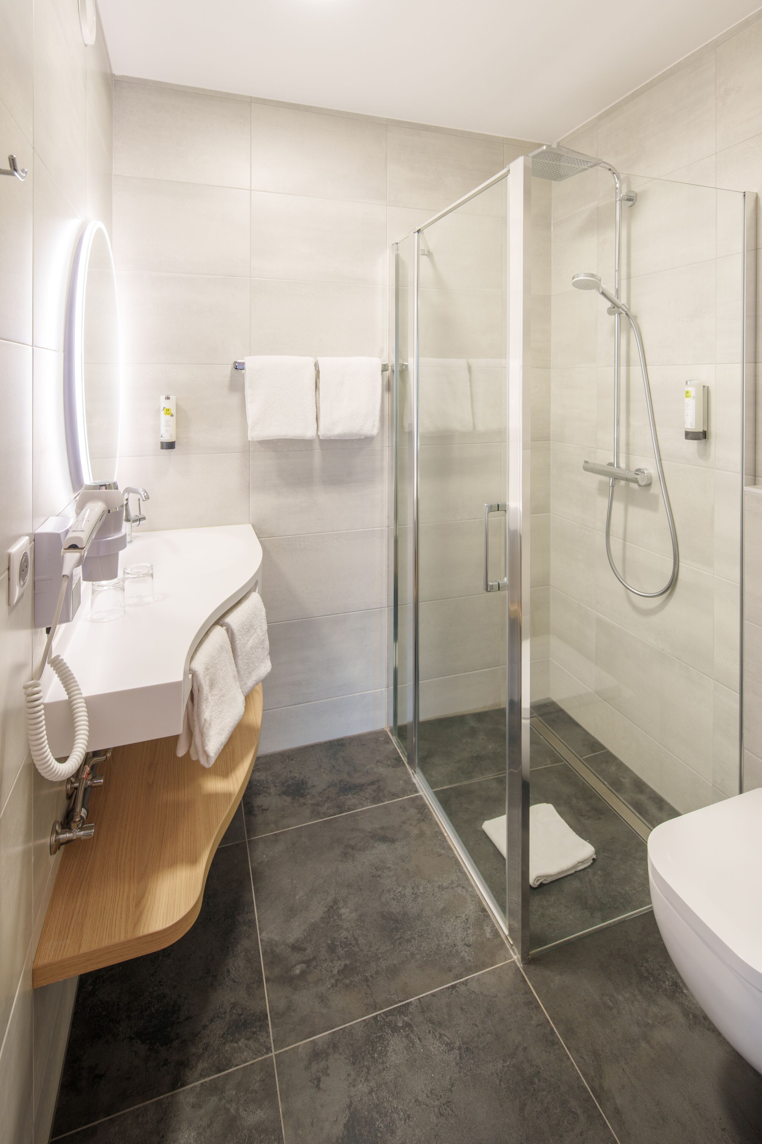 standard double room | bathroom | shower, rainfall showerhead, hair dryer, towels