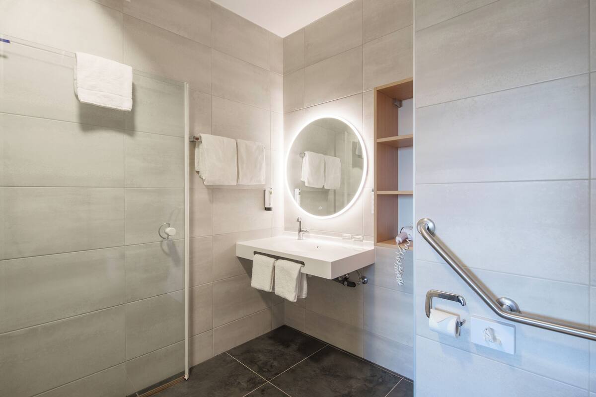 standard twin room | bathroom | shower, rainfall showerhead, hair dryer, towels