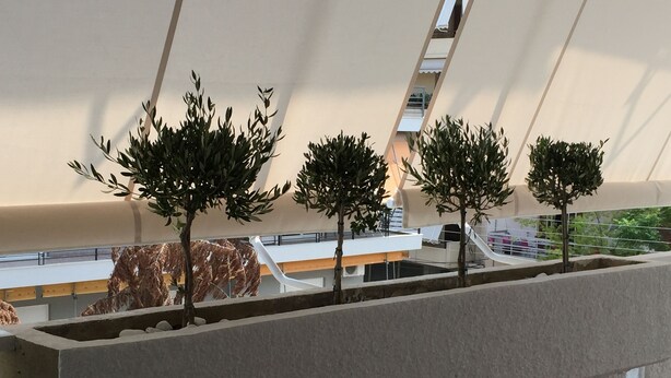 A modern architectural model with a minimalist design, featuring a series of trees and a curved structure. - Captain's Luxury Suite (Nea Smirni)