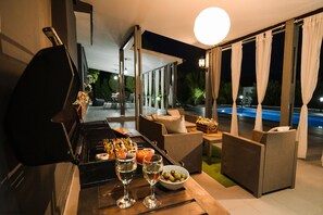 An outdoor patio with a grill, wicker furniture, a pool, and a table with drinks. - Alexs Villa, Nata -  3 Beds, 2 Baths, Private Pool. Wi-Fi, BBQ's, Refurbished (Paphos)