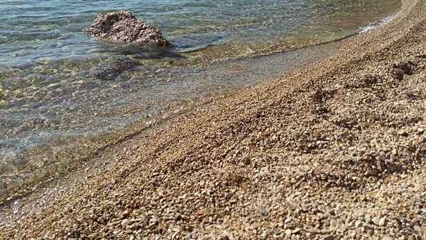 A pebble beach with clear water and rocky outcrops. - Apartments Dalmatinka Metajna Novalja (Novalja)