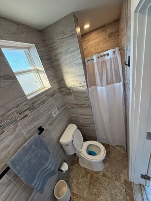 Shower, hair dryer, towels, toilet paper