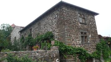A stone building with a traditional design, featuring a prominent entrance and windows.