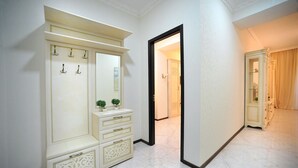 A hallway with a large, ornate wardrobe, a mirror, and a door leading to another room. - Apartment on Kostava str. (Tbilisi)