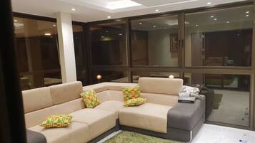 Deluxe Apartment | Living area | 40-inch flat-screen TV with satellite channels, TV