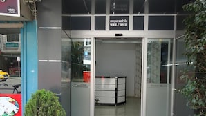 A hotel entrance with a revolving door, a welcome sign, and a visible reception desk. - Hotel Ozkar (Mersin)