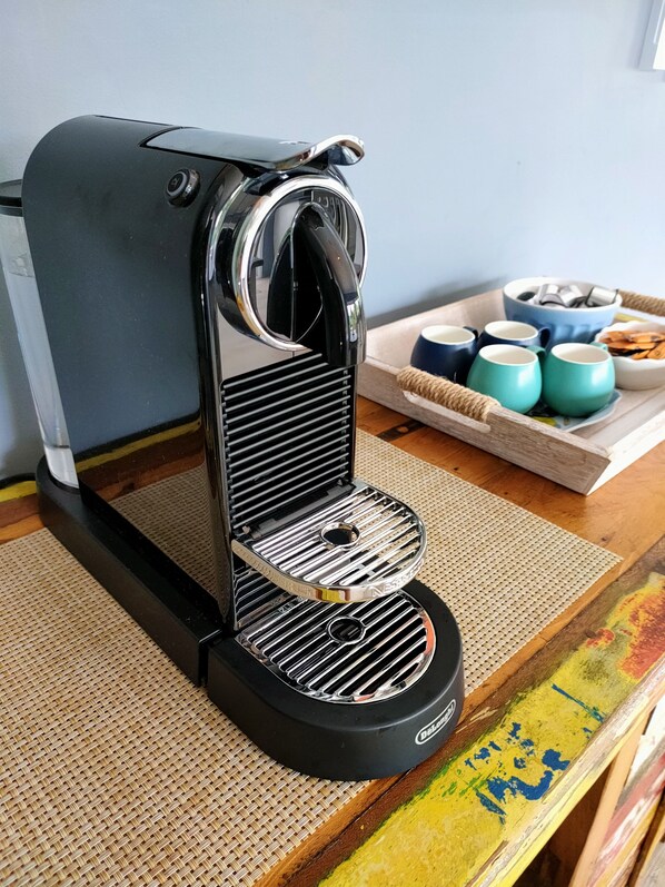 A Nescafé coffee machine on a woven mat.