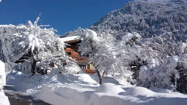 A snow-covered mountain landscape with a wooden chalet. - NEW, EXCLUSIVE, COZY apartment !!!! (St. Gallenkirch)